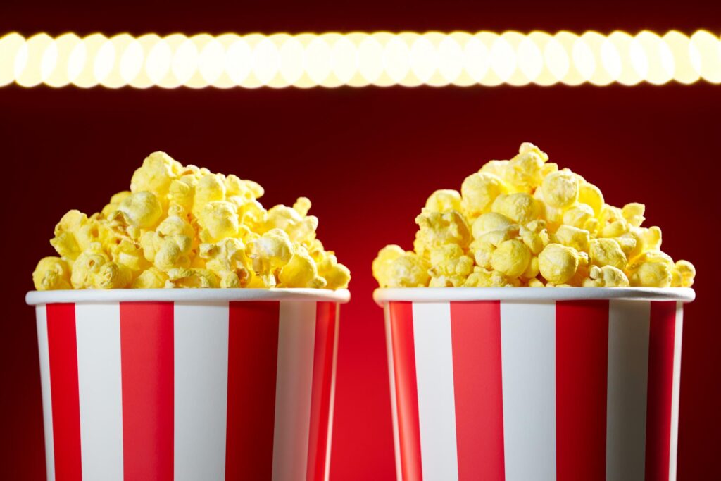 two popcorns in a stripes bucket