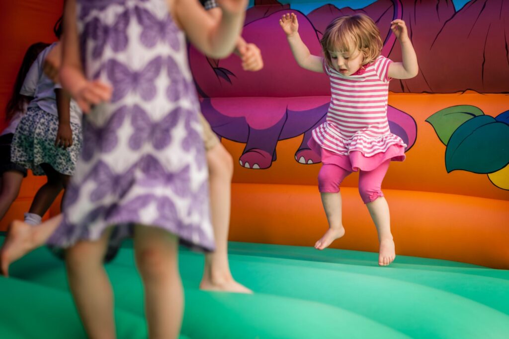 kids jumping around the bouncy inflatable playground